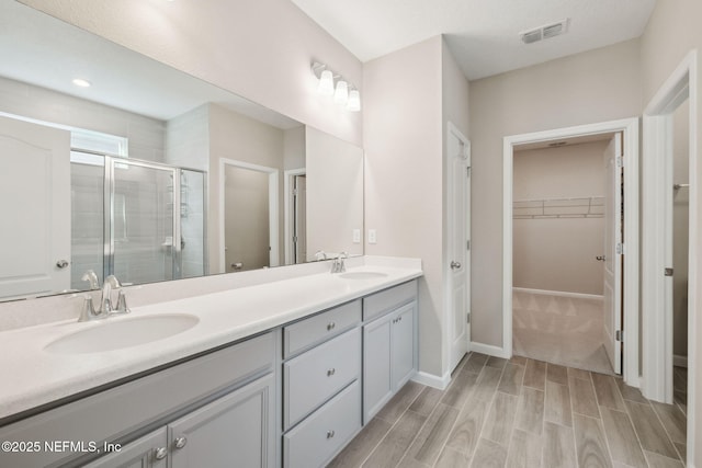 bathroom with vanity and walk in shower