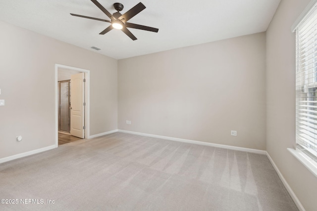 carpeted empty room with a healthy amount of sunlight and ceiling fan