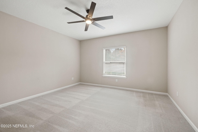 spare room with light carpet and ceiling fan