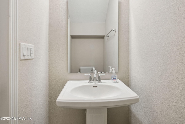 bathroom featuring sink and toilet