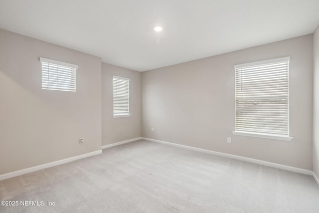 spare room featuring light colored carpet