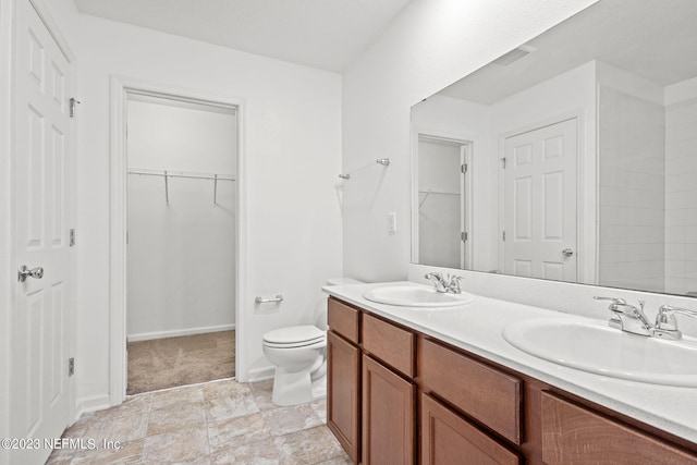 bathroom featuring toilet and vanity