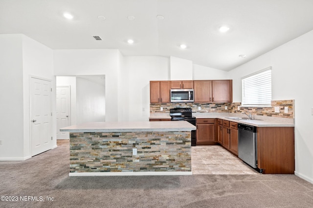 kitchen featuring tasteful backsplash, stainless steel appliances, a center island, lofted ceiling, and light colored carpet