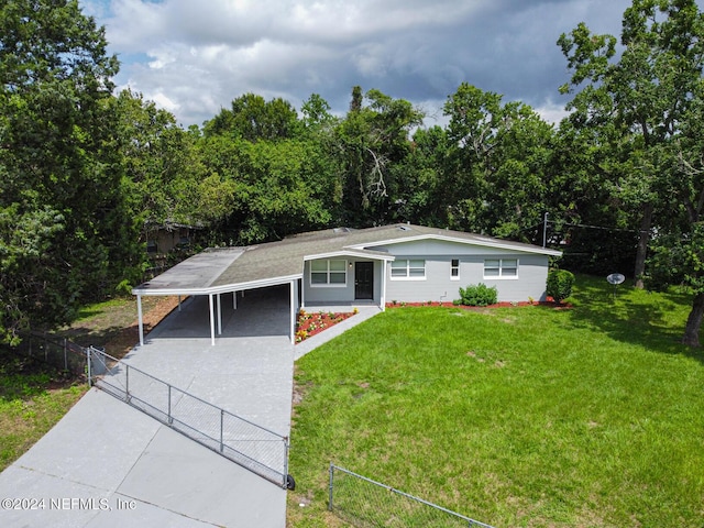 view of front facade with an attached carport, a gate, fence, driveway, and a front lawn