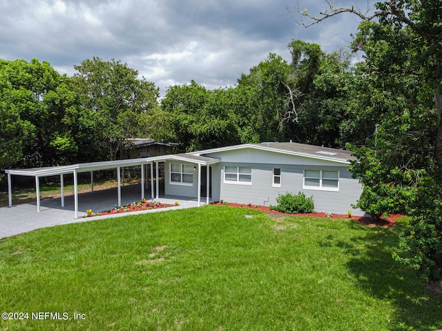 exterior space featuring a front lawn and a carport