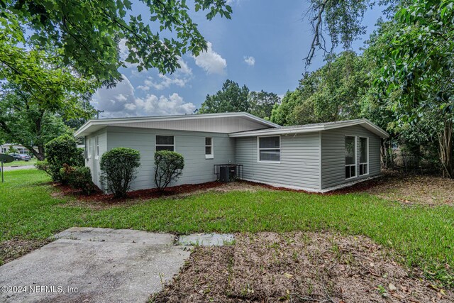 exterior space featuring a yard and cooling unit