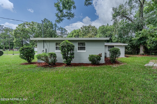 view of side of home featuring a yard