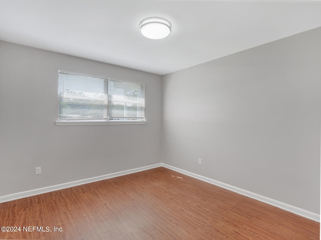 empty room with hardwood / wood-style flooring