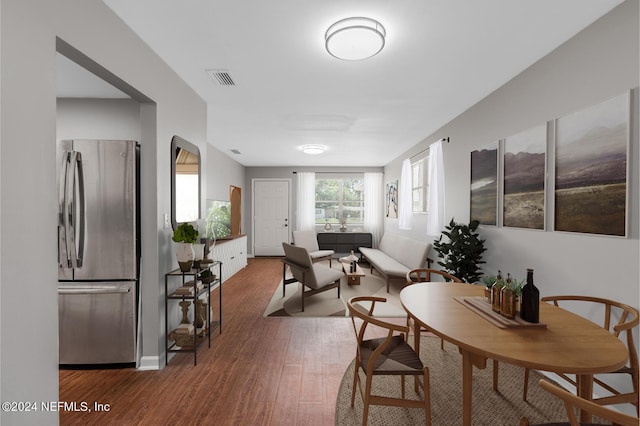 dining space featuring wood finished floors and visible vents