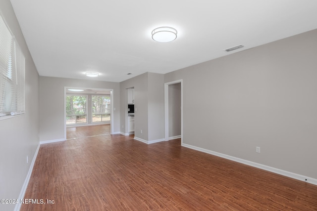 unfurnished living room with hardwood / wood-style flooring