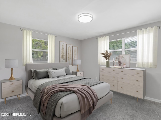 bedroom featuring baseboards and light carpet