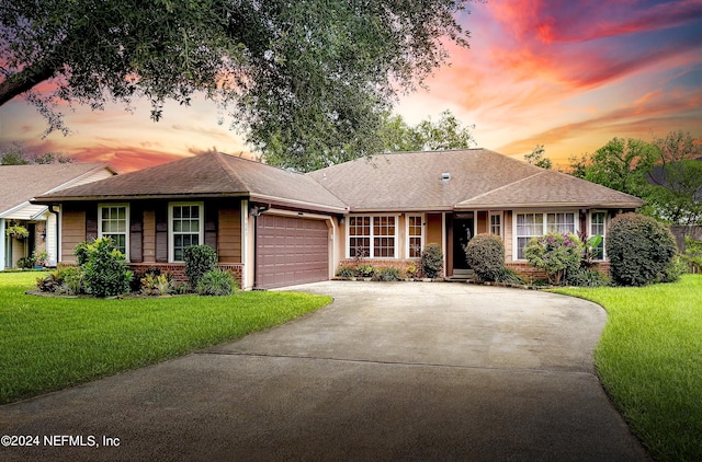 single story home with a yard and a garage