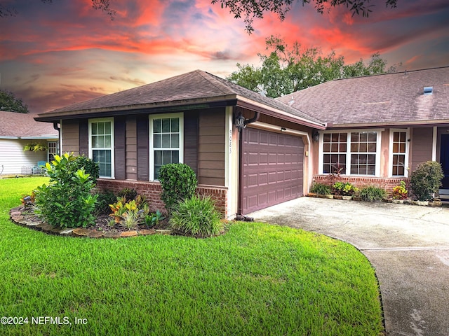 single story home with a yard and a garage