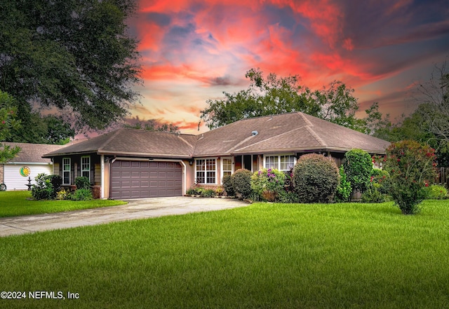 ranch-style house with a lawn and a garage