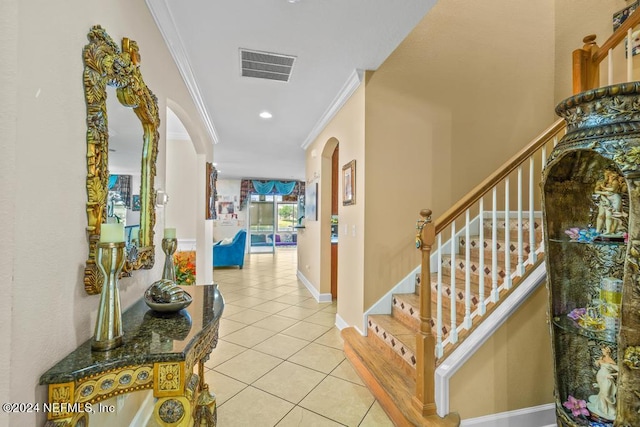 hallway with crown molding and light tile patterned floors