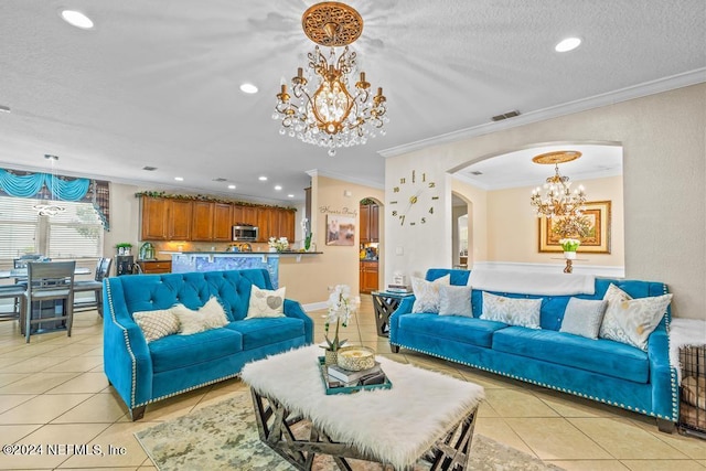 tiled living room featuring a textured ceiling, ornamental molding, and a notable chandelier