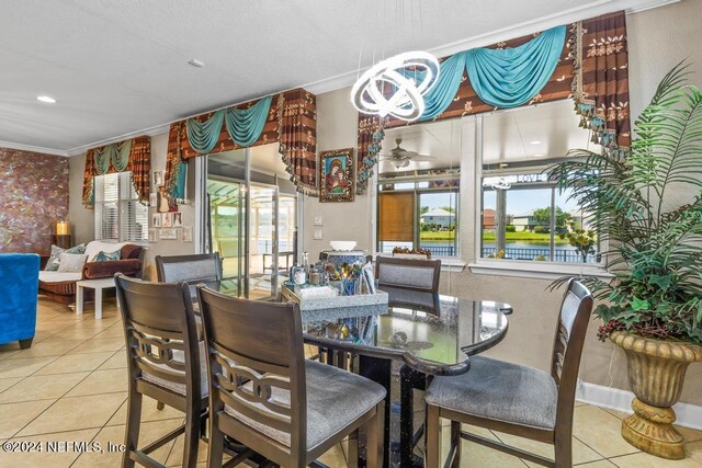 dining area with ornamental molding and light tile patterned floors