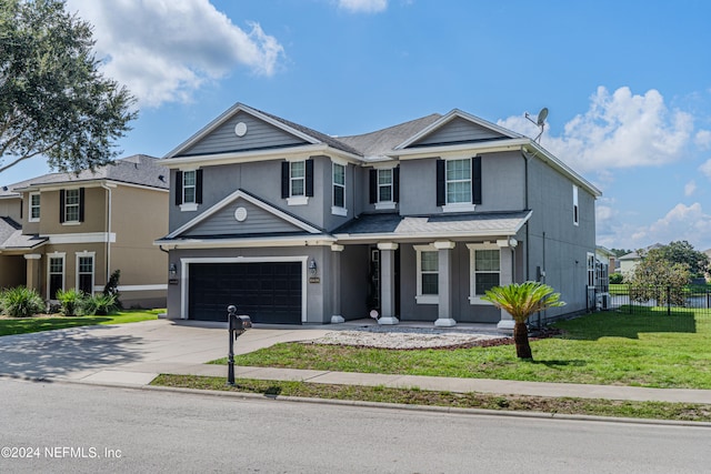 view of front property with a garage and a front lawn