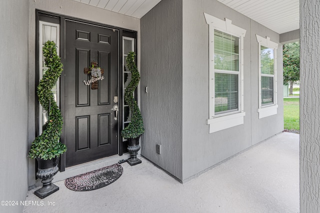 view of exterior entry with covered porch