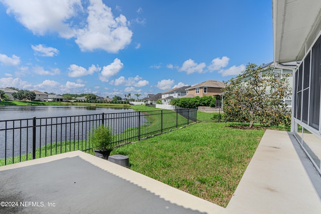 view of yard featuring a water view and a patio area