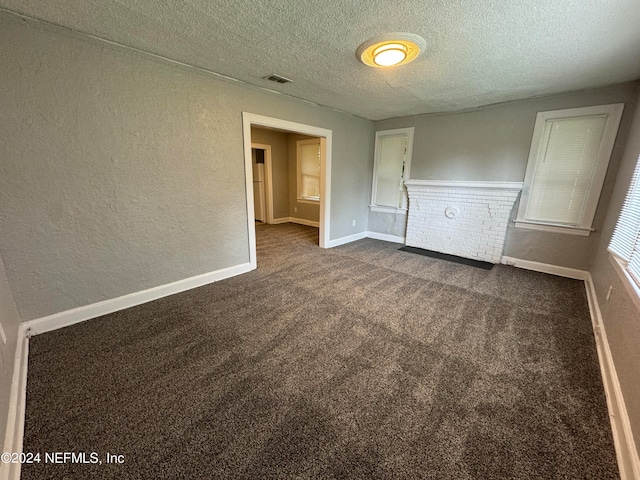 carpeted spare room featuring a textured ceiling