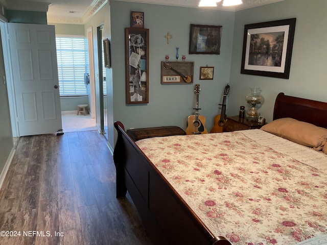 bedroom featuring crown molding and dark hardwood / wood-style floors