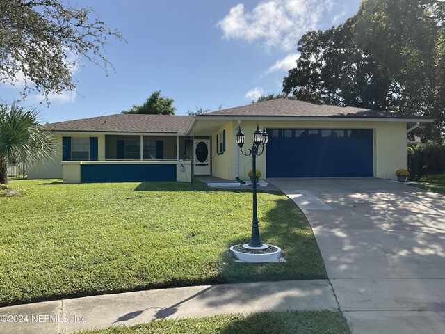 view of front of house with a front yard and a garage