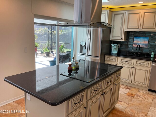 kitchen with decorative backsplash, island exhaust hood, appliances with stainless steel finishes, sink, and a center island