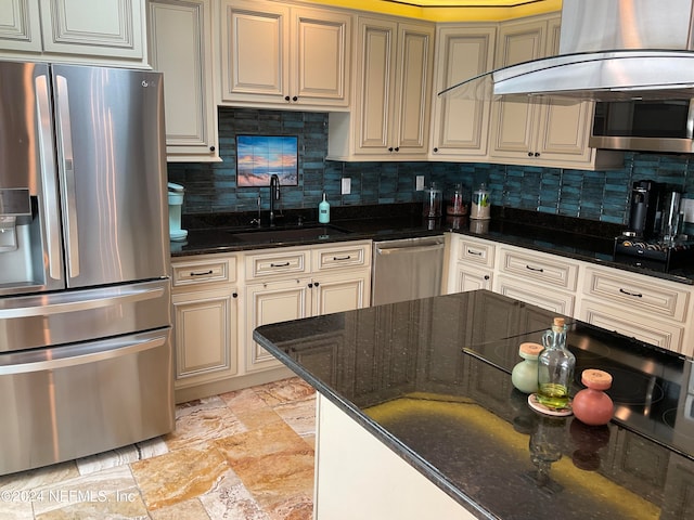 kitchen with sink, appliances with stainless steel finishes, decorative backsplash, and dark stone counters