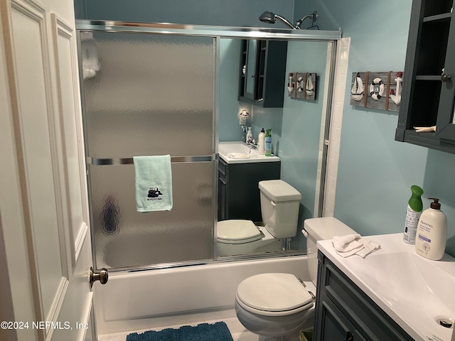 full bathroom with vanity, toilet, tile patterned floors, and shower / bath combination with glass door