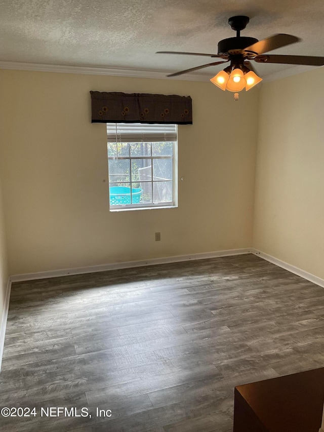 spare room with ceiling fan, hardwood / wood-style flooring, a textured ceiling, and crown molding