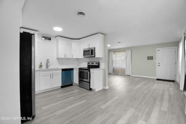 kitchen featuring stainless steel appliances, backsplash, visible vents, and light countertops