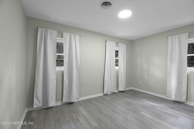 empty room with light hardwood / wood-style flooring