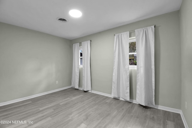 spare room with light wood-type flooring