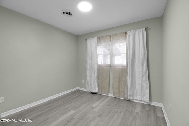 empty room with light hardwood / wood-style floors