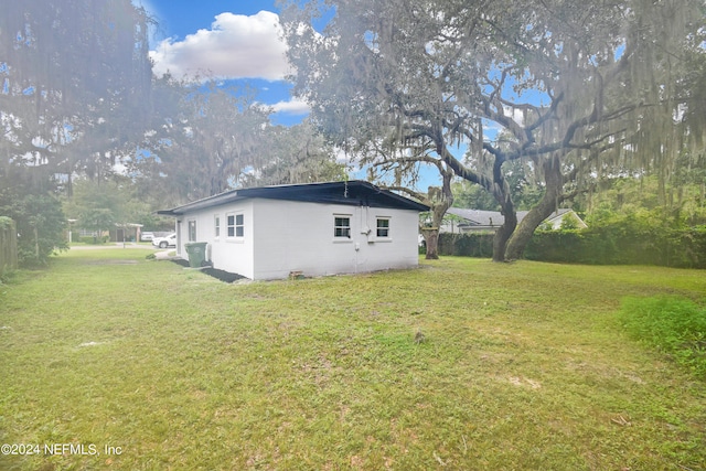 view of side of home featuring a lawn