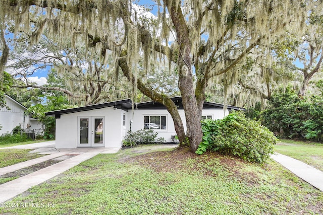 view of front of property with french doors and a front yard