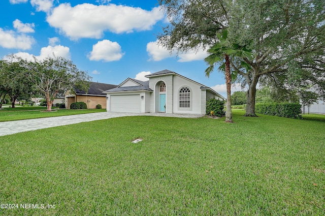 view of front of house featuring a garage and a front lawn