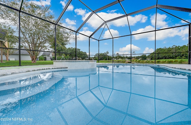 view of pool with a lanai and a yard