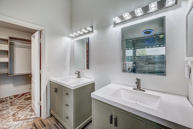 bathroom with a shower, hardwood / wood-style flooring, and vanity