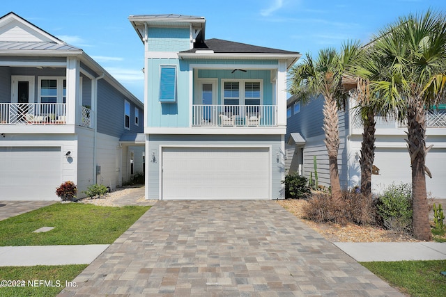 beach home featuring a porch, a garage, and ceiling fan