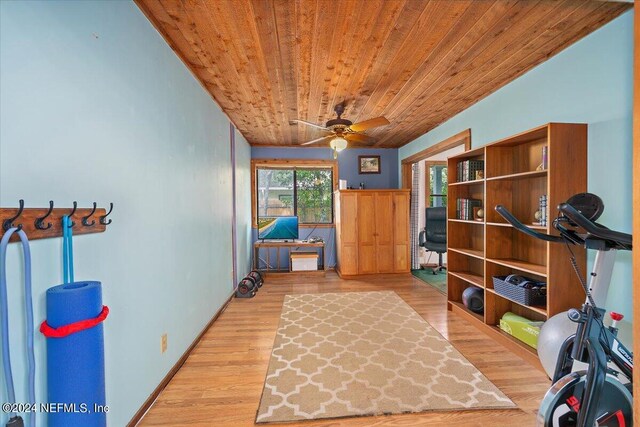 interior space with light wood-type flooring, wood ceiling, and ceiling fan