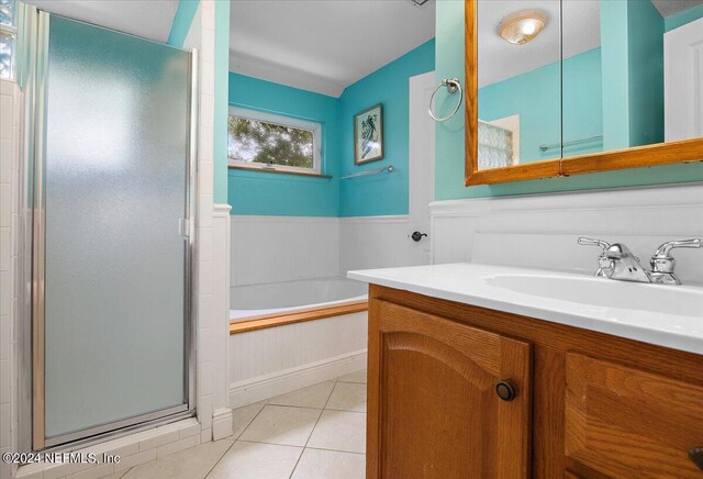 bathroom featuring vanity, independent shower and bath, and tile patterned floors