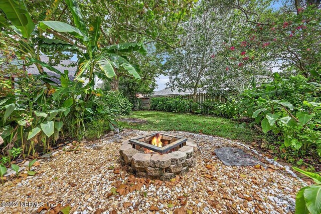 view of yard featuring an outdoor fire pit