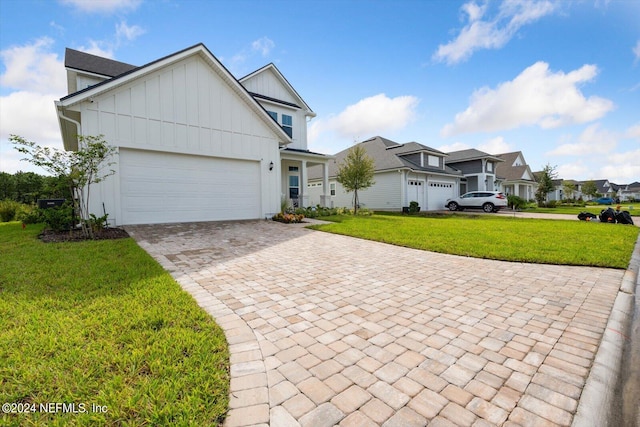 view of front facade featuring a front yard and a garage