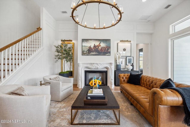 living room with hardwood / wood-style floors, a fireplace, and a chandelier