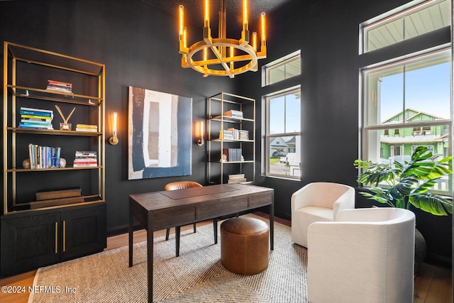 home office with hardwood / wood-style floors, a chandelier, and a healthy amount of sunlight