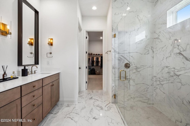 bathroom with a shower with door and vanity