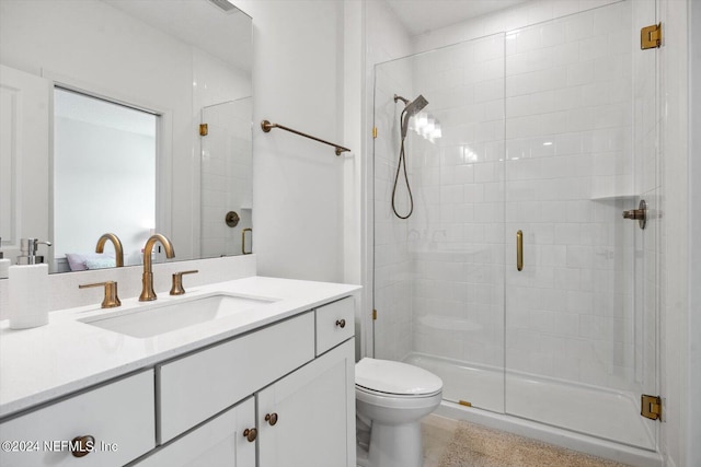 bathroom with vanity, toilet, and an enclosed shower