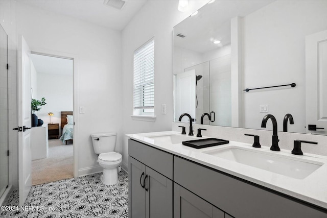 bathroom featuring vanity, toilet, walk in shower, and tile patterned flooring